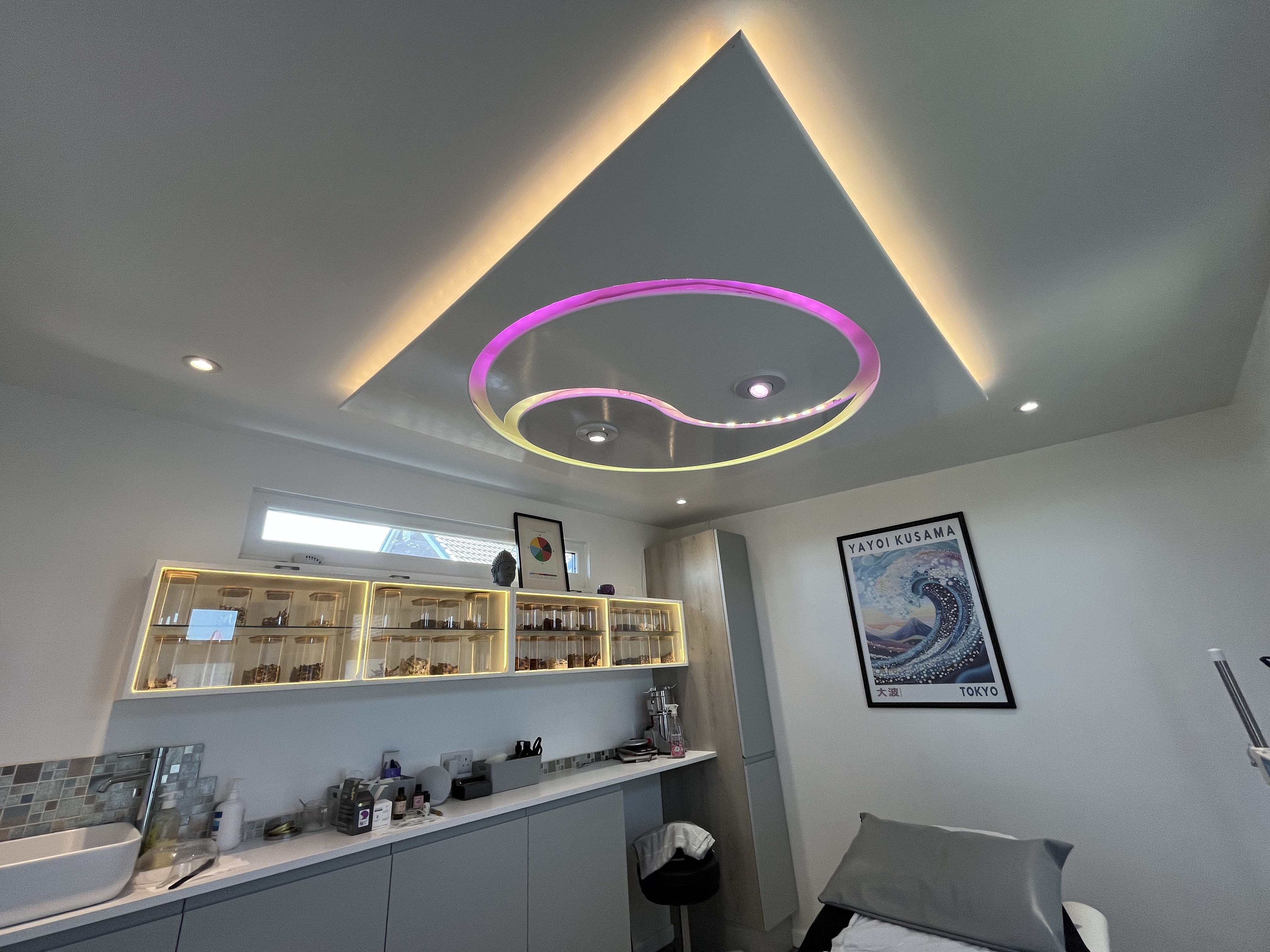 Balance Acupuncture treatment room showing the full herb dispensary cabinet